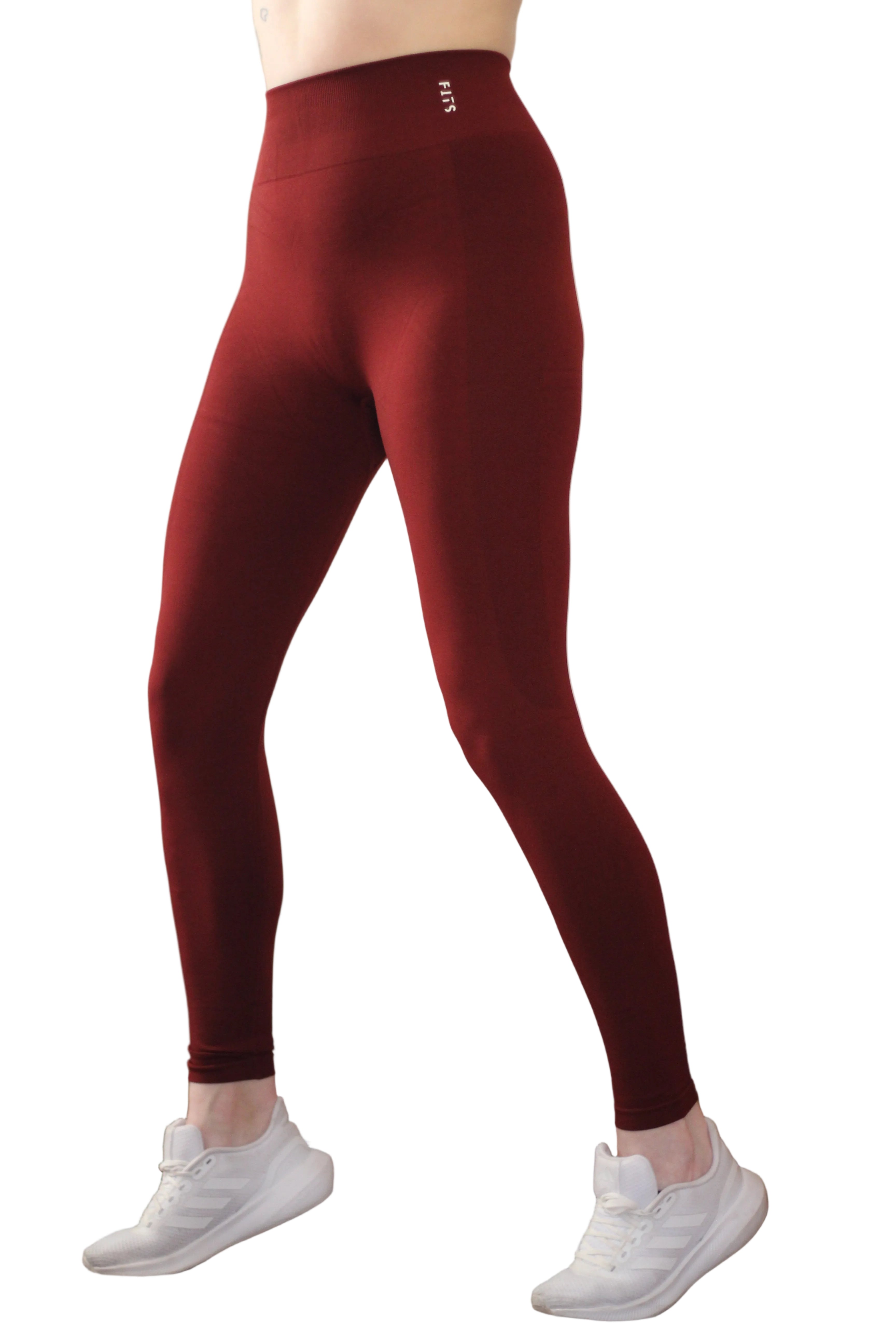 Red leggings worn by a person against a neutral background